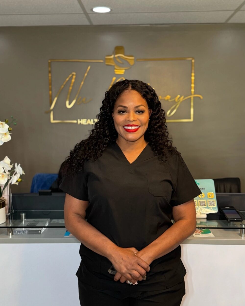 Lisa Nelson welcoming visitors at the Nu Pathway front desk